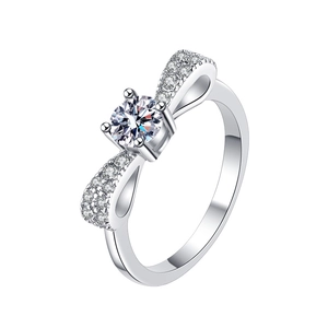 S925 sterling silver bow ring featuring a round moissanite center stone on white background