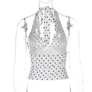 Detail of white halter neck top with black polka dots featuring backless tie-up design