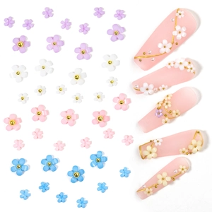 Flat lay of colorful 3D resin flowers and pearls for DIY nail art decoration