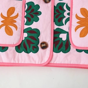 Women's pink floral cotton jacket with abstract leaf print and amber-patterned buttons