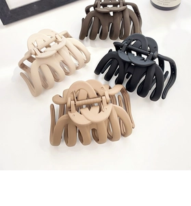 Set of four large matte pumpkin hair claws in beige, khaki, dark brown, and black colors