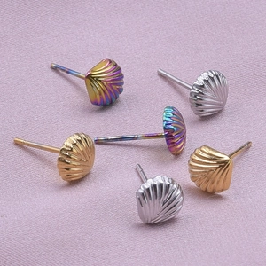 Detailed view of sea shell stud earrings in gold, silver and rainbow surgical steel