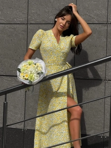 Detail of V-neck wrap dress with floral print and high side slit for summer fashion