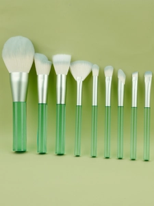 Detailed flat lay of 10 green transparent handle makeup brushes with soft gradient bristles