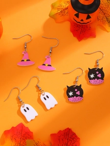 Detail of Halloween earring set with witch hat, ghost, and cat designs on orange background