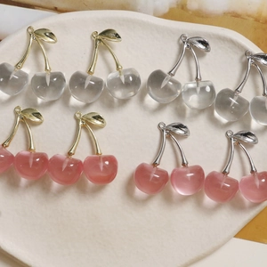 Macro detail of cherry-shaped resin charms for DIY jewelry making in multiple colors