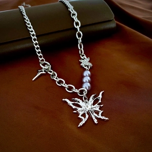 Detail of silver butterfly pendant necklace with lavender pearls and cubic zirconia