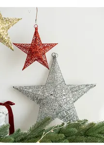 Close-up of hollow woven Christmas star ornaments with glitter finish in red gold and silver