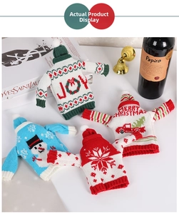 Detail of knitted Christmas wine bottle covers with mini hats and festive patterns