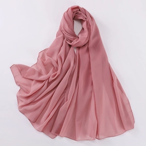 Close-up of pink pearl chiffon shawl with sparkling rhinestones and soft texture