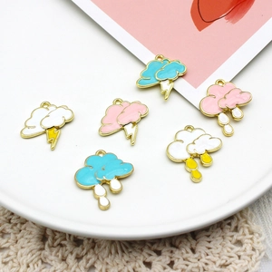 Detailed view of colorful cloud enamel charms with lightning and raindrops on a white plate