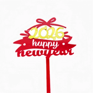 Detailed view of red and gold acrylic 2026 Happy New Year cake topper with bow detail