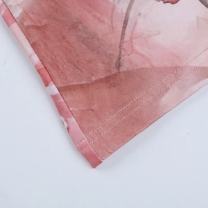 Detail of the pink floral print fabric and fine stitching on the long sleeve dress