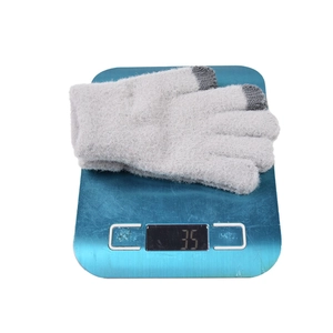 Winter thermal knit gloves in light grey showing 35g weight on a scale with touch screen tips