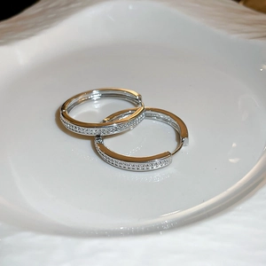 Close-up of silver hoop earrings with shimmering white cubic zirconia pave setting