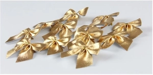 Close-up of golden metallic texture decorative bows for Christmas tree and gift wrapping