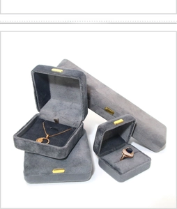 Detailed view of gray velvet jewelry boxes for rings and necklaces on white background