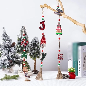 Wooden Christmas gnome and car ornaments with colorful beads and tassels hanging on a branch