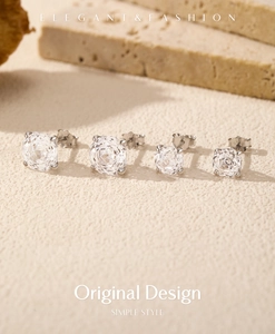 Macro view of four-claw 925 silver stud earrings with rose-cut sparkling round gemstones