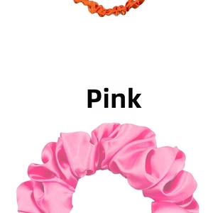 Detailed close-up showing the smooth satin texture and pink pleated elastic of the scrunchie