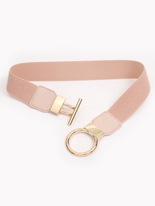 Detail of light pink elastic belt with gold metal ring buckle and leather connection