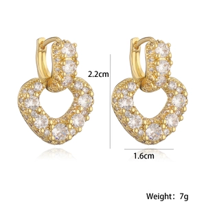 Detail of gold heart earrings with white zircons showing 2.2cm height and 7g weight
