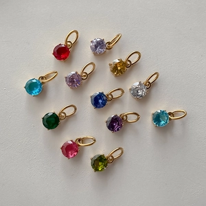 Detailed macro view of colorful round stainless steel crystal pendants for DIY jewelry design