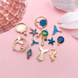 DIY jewelry charms featuring 12 mixed enamel mermaid tails and shells in sea theme