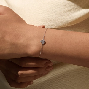 S925 sterling silver bracelet with clover moissanite pendant on a model's wrist
