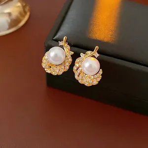 Elegant feather pearl earrings with micro-pave cubic zirconia in gold plating