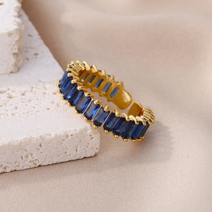 Detailed macro of gold adjustable ring with sapphire blue baguette cut zircons