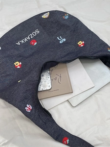 Blue denim crossbody tote bag with colorful mini embroidery and spacious interior for books