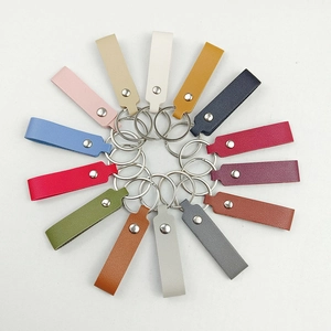 Flat lay of colorful PU leather keychains in 14 shades arranged in a circular radial pattern