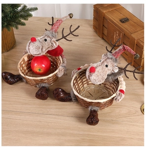 Close-up of two woven reindeer Christmas baskets with plush antlers and holiday bells