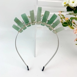Detail of handmade silver wire headband with green natural stone and pearl accents