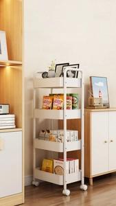 Detail view of a 4-tier white rolling cart with storage baskets and swivel wheels