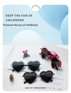 Detailed view of heart-shaped kids sunglasses with scalloped floral edges in multiple colors