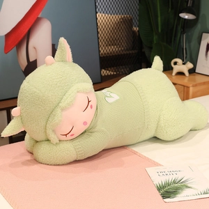 Close-up of a sleeping lamb plush toy made of soft green sherpa fleece with a cozy sweater