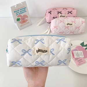 Quilted bow pencil case and cosmetic bag in white pink colors with zipper closure