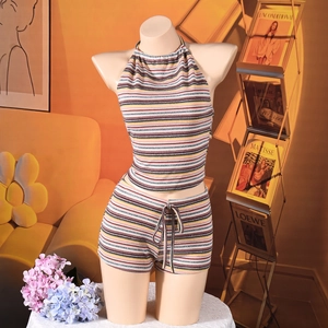 Detail of multi-color striped knit halter top and drawstring shorts on a model