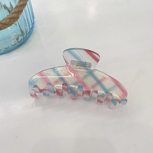 Pink and blue checkered acetate hair claw clip with large striped design on white background