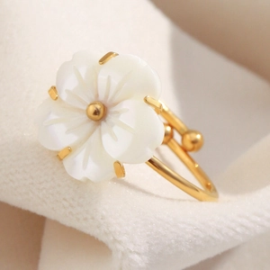 Macro detail of 18K gold plated flower ring with white mother of pearl petals