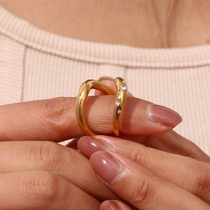 Detail showing 18K gold-plated wavy rings with micro-set stones on fingertips