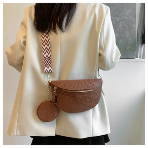Detail of woven brown waist bag with detachable round coin purse and geometric shoulder strap