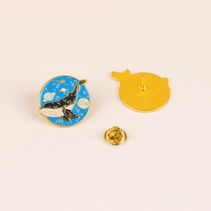 Starry sky whale enamel pin with blue galaxy pattern and gold metal butterfly clasp