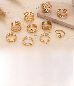 Detailed close-up of gold moon and star titanium steel rings with vacuum plating