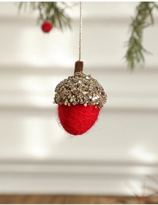 Detail of red felt acorn ornament with gold sequins and beads for Christmas decor