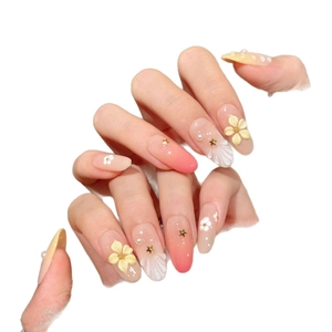 Pink and orange gradient press-on nails with 3D flower carvings and pearl accents