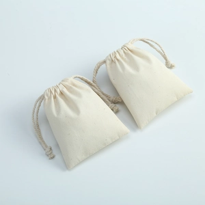 Two cream white cotton canvas drawstring pouches for jewelry storage on white background