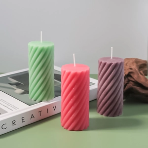 Detailed view of spiral pillar silicone candle molds in pastel colors for DIY decor